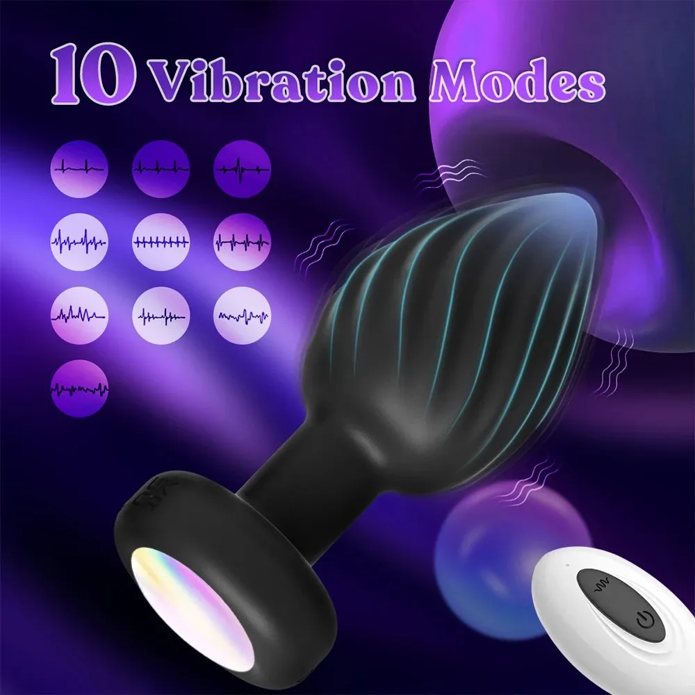 Plug anal vibratório preto com base iluminada e controle remoto branco, com 10 modos de vibração